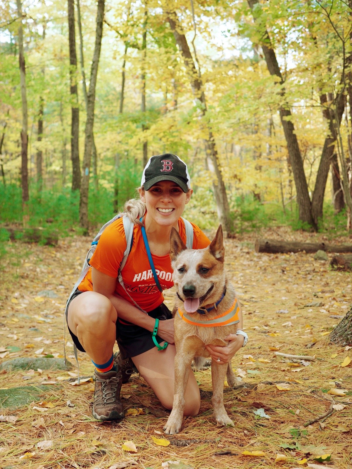 Cait hiking in the woods with her dog
